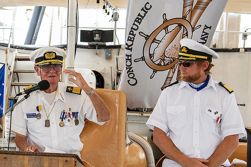 man looking at a navy captain speak