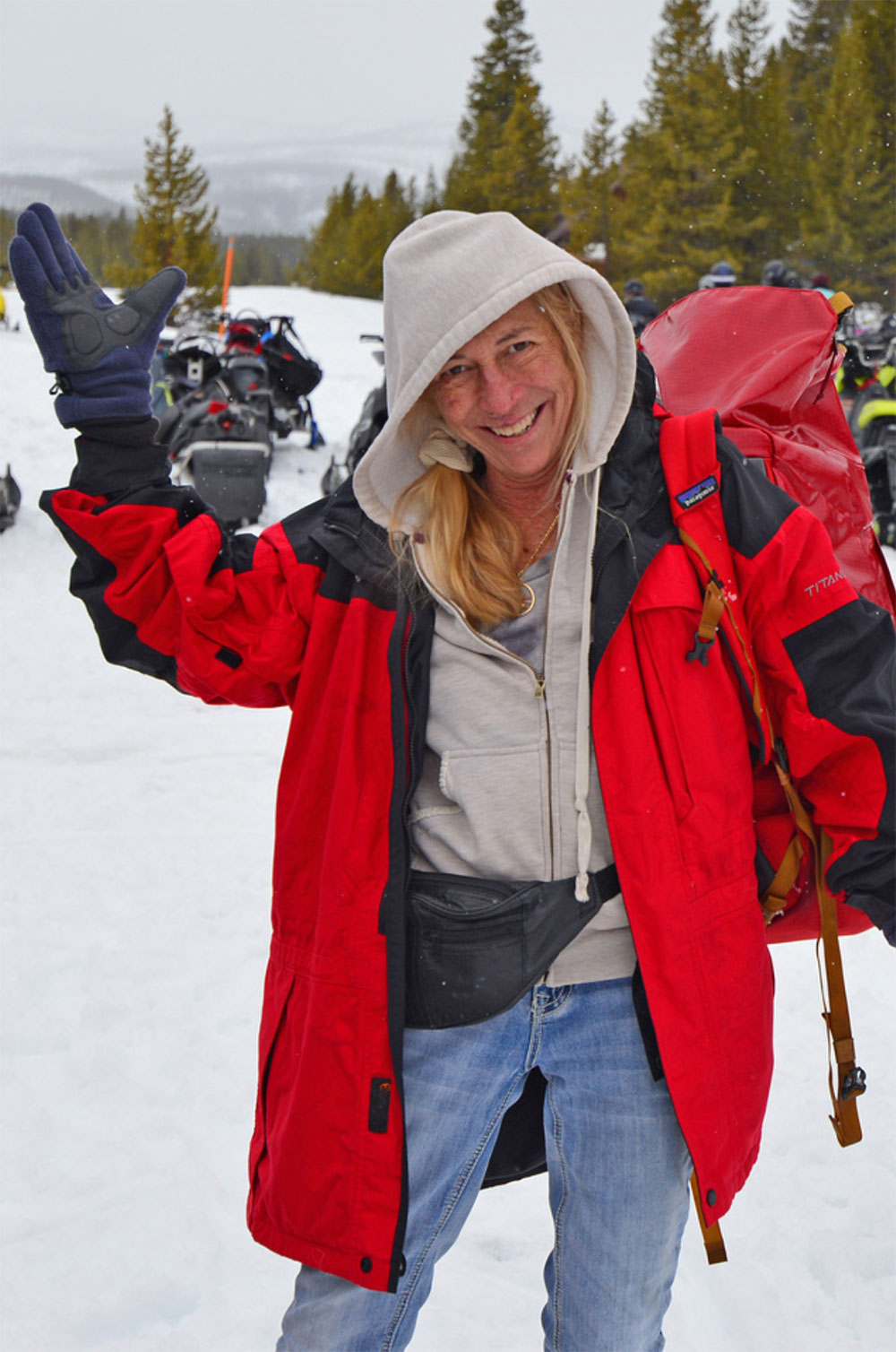 Mary Martin on a snowy mountain with motorcycles in background